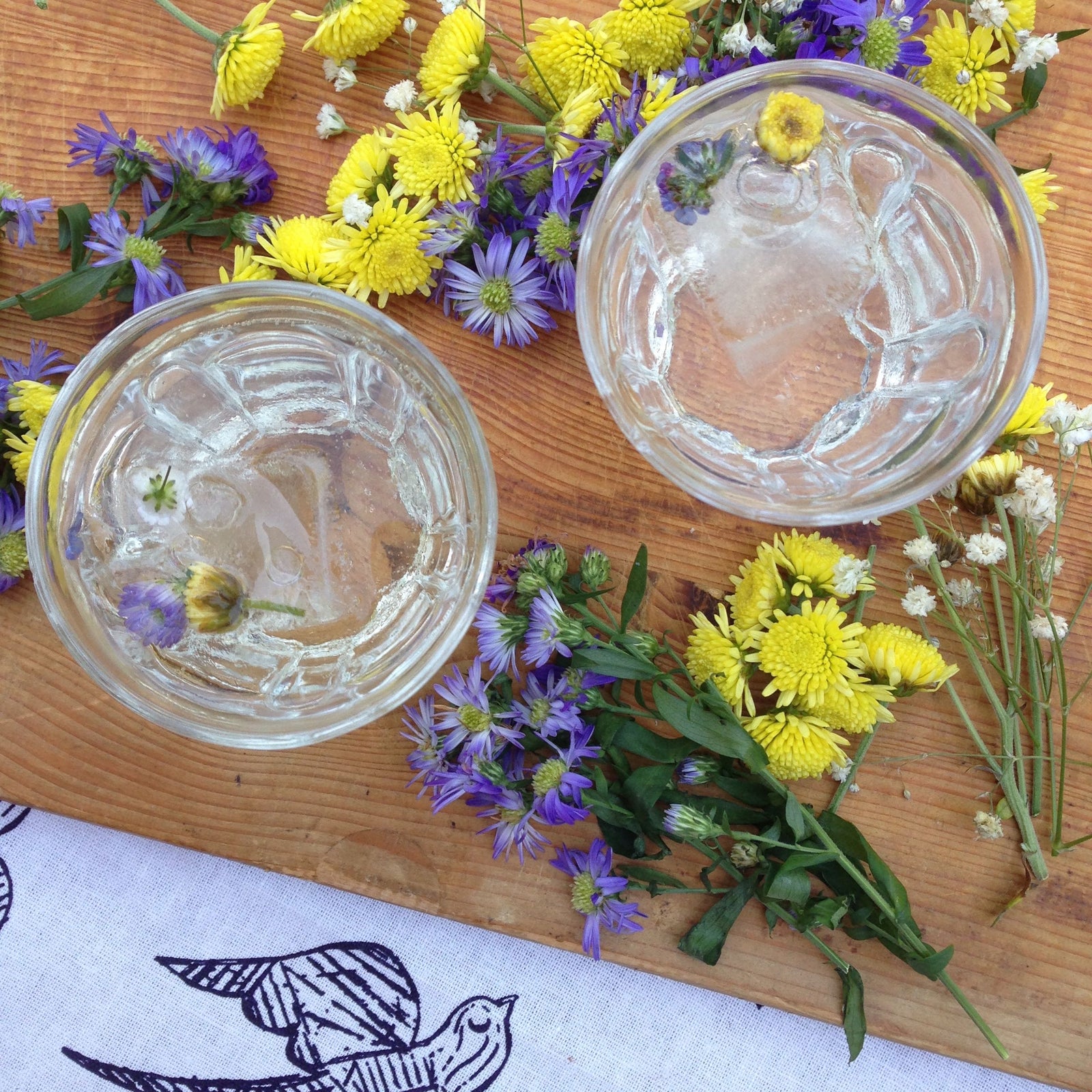 Midsummer Gin & Elderflower Cocktail with edible flowers featured with Katia Swallow Pattern Linen Napkin