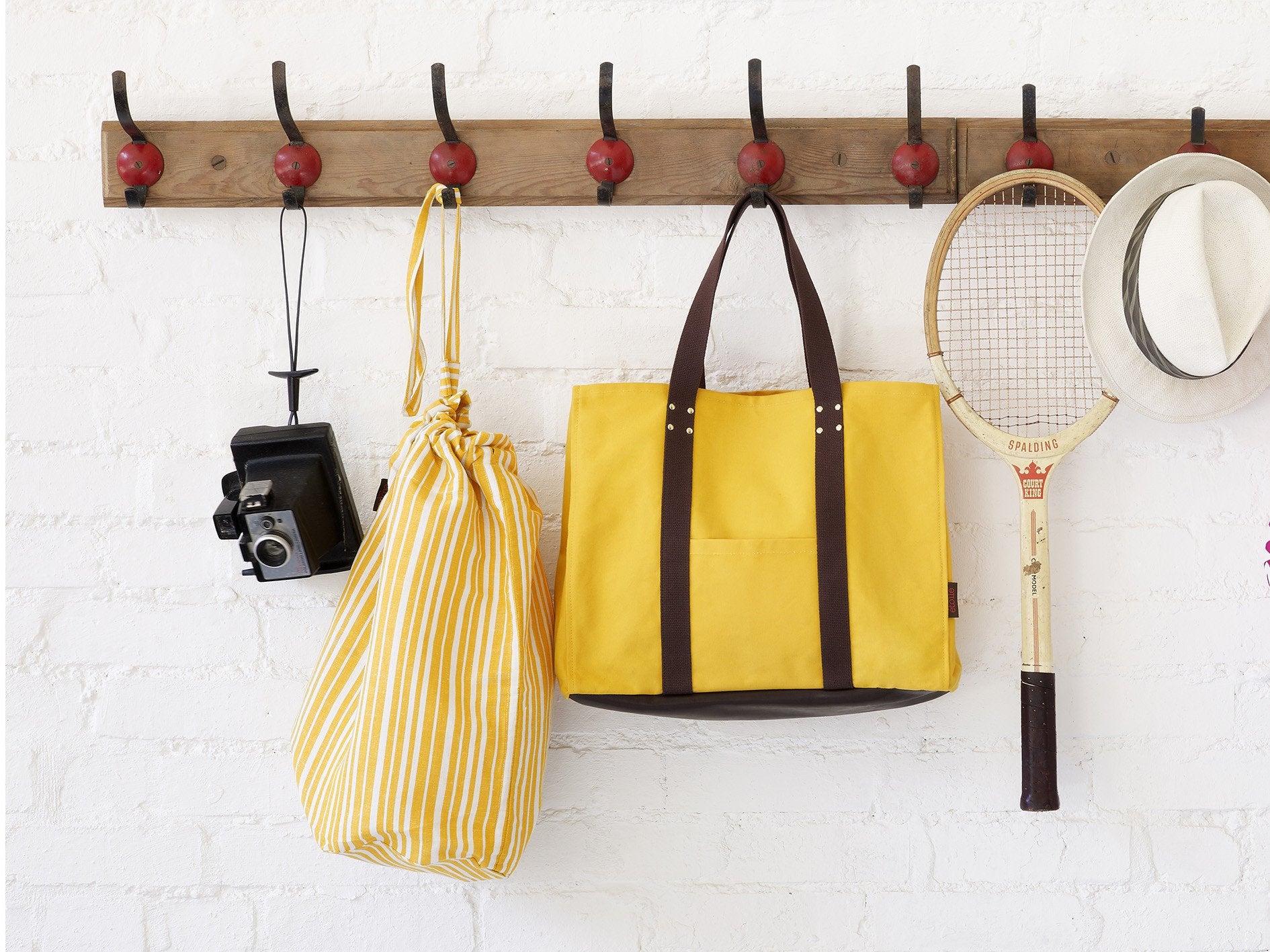 Tote bags, overnight bags, clutches and hand bags in resin coated dyed canvas. Hand made in England with quality leather and brass trims. Ships from Canada worldwide including the USA