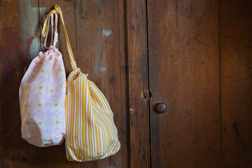 Geometric pattern stripe pink yellow laundry storage bags canada usa drawstring