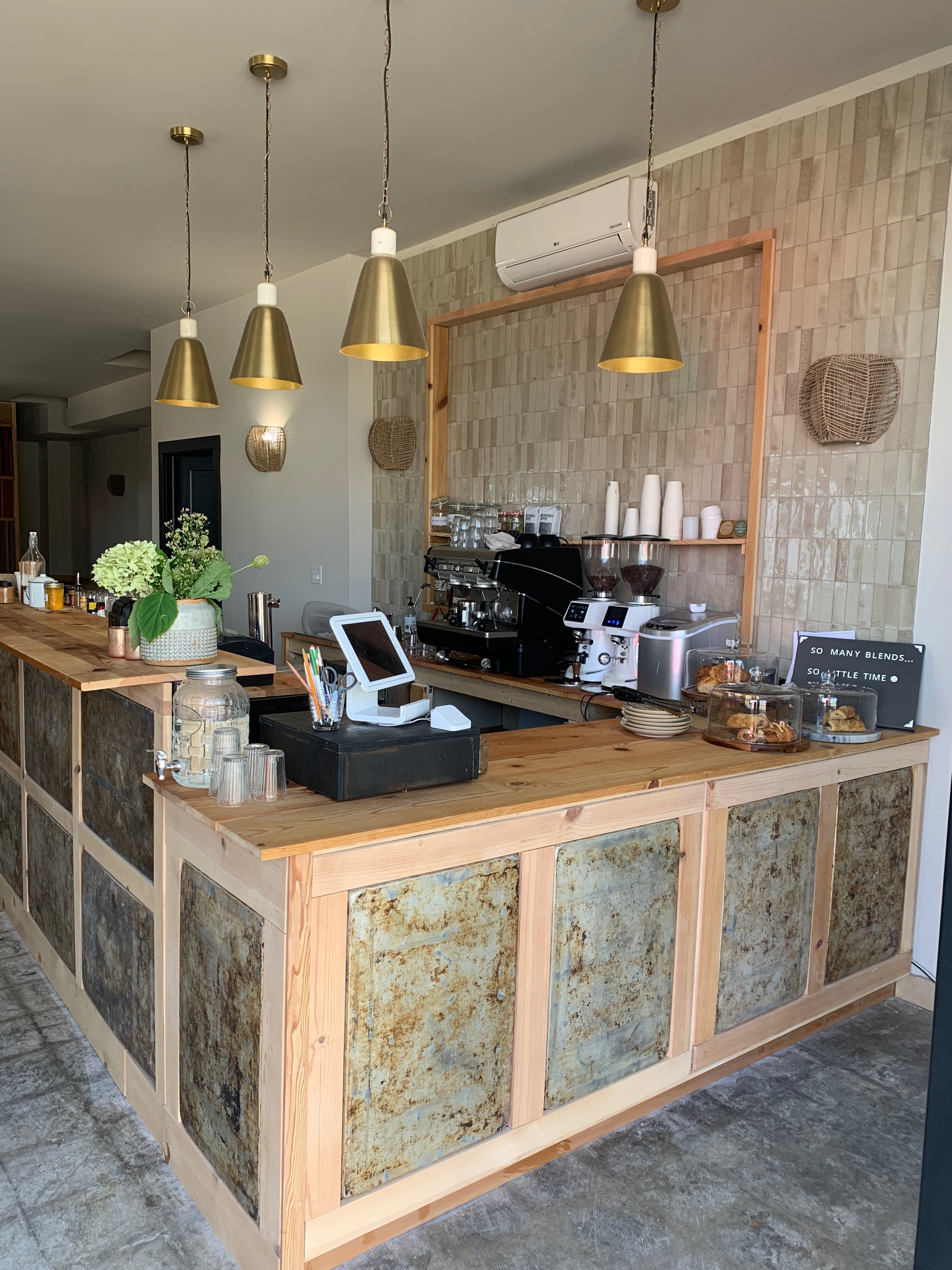 Wooden counter with coffee equipment and decor in a modern cafe setting