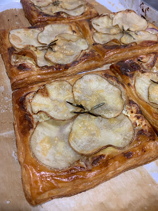 Pastry with potato slices on a baking tray